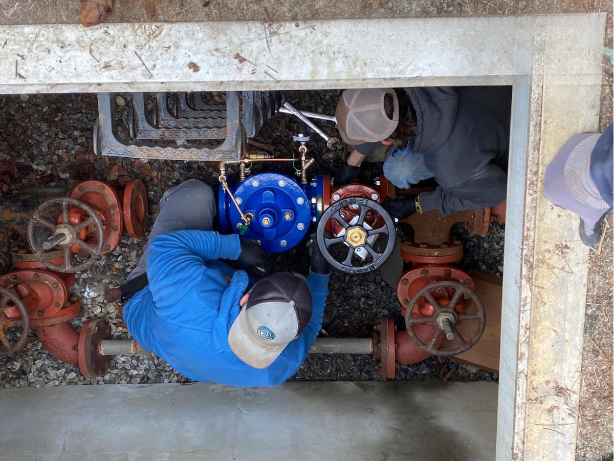 EMS technicians servicing valves and equipment in the field.