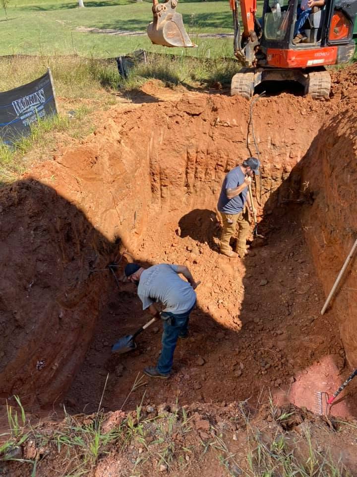 EMS crew excavating for a wastewater system installation.